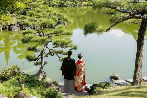 水辺の浮見堂でカメラ目線の新婦
