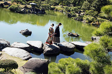 枯山水の庭を手を引いて歩く新郎新婦